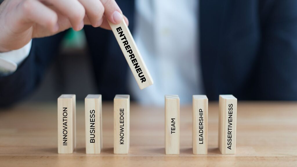 Entrepreneurial person putting dominoes up on a table