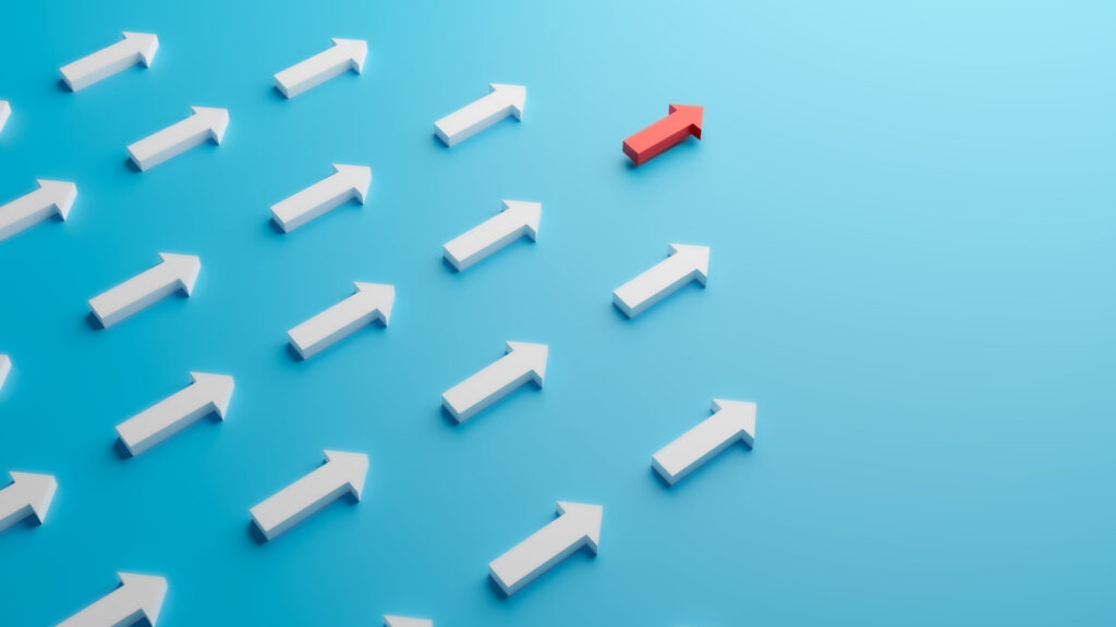Arrows on a paper with one red leader arrow at front