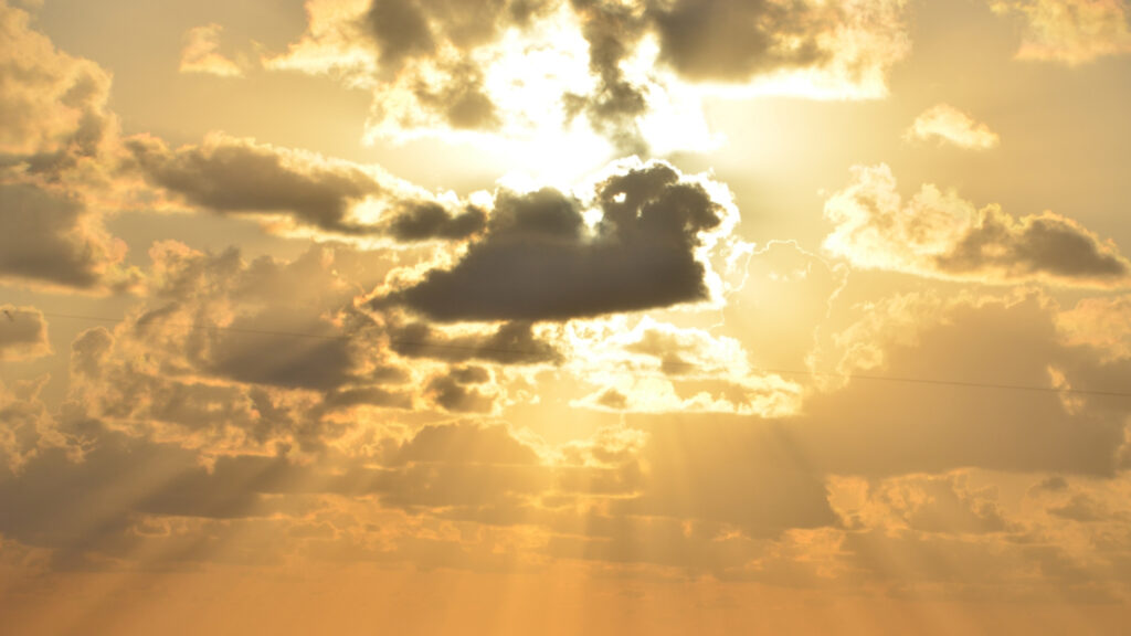 sunshine radiating through the clouds in a majestic way